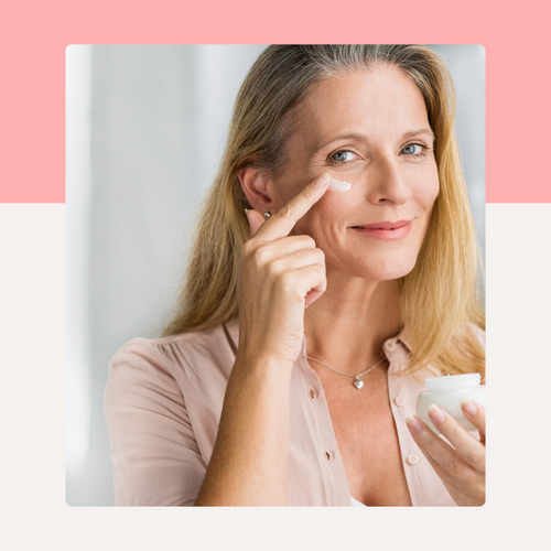 Woman applying skincare products on pink split background