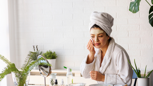 Woman applying face mask