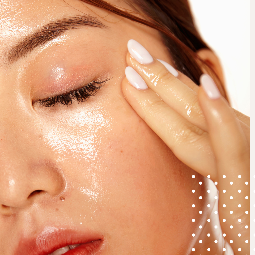Close-up of a woman applying a skincare product to her face with a cotton pad.